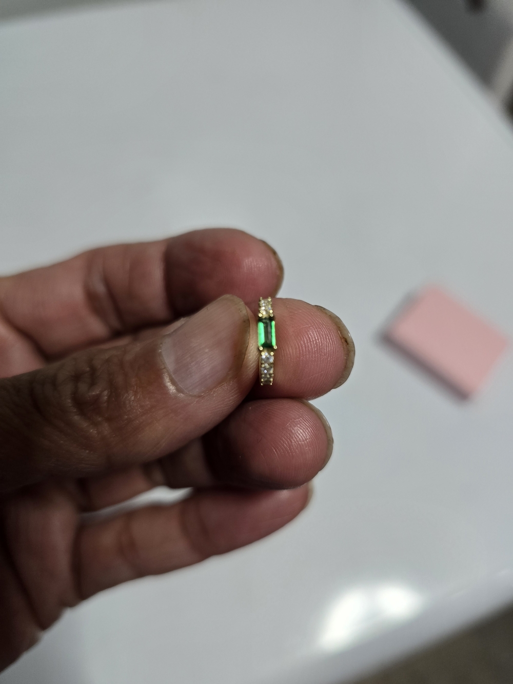 New 925 silver hoop nose and ear piercing with a green stone.
